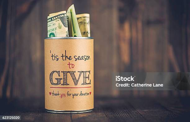 Charity Collecting Tin Against Wooden Background American Holiday Fundraising Stock Photo - Download Image Now