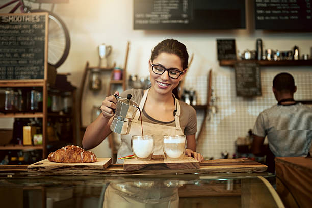 if you didn't love coffee before, you certainly will now - coffee serving cafeteria worker checkout counter imagens e fotografias de stock