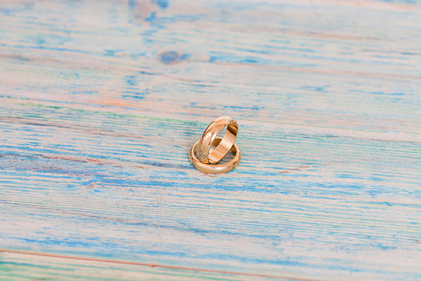 istock Wedding rings on wooden table 623127354