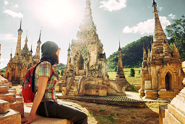 istock Traveller with backpack resting and looks at Buddhist stupas. My 623173374