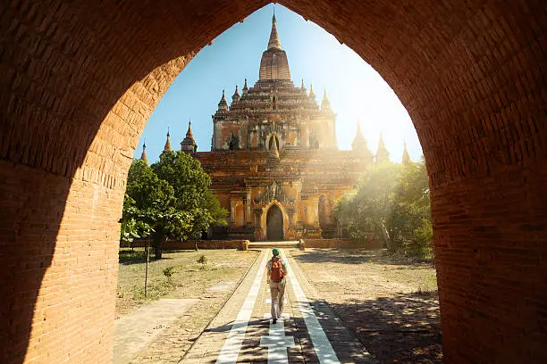 Traveler walking along the road to the Htilominlo temple in Bagan, Myanmar