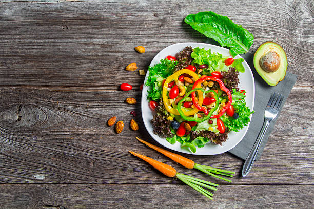 istock fresh vegetable salad on wood table background 623174500