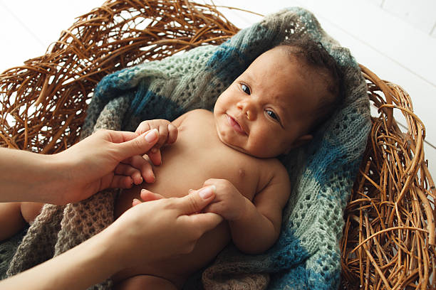 istock Cute newborn baby holding mom hands in cradle 623176846