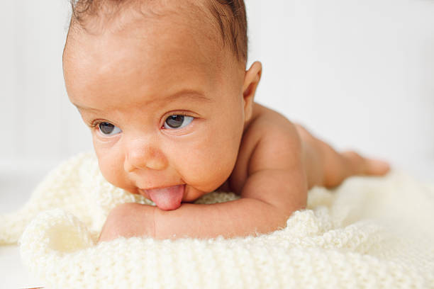 istock Newborn baby laying stomach down on bed 623176928