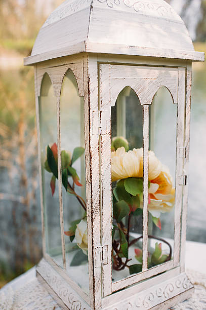 istock Vintage lantern with beautiful flowers close-up 623177538