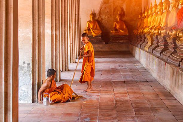 istock Two novices playing with funny in old temple 623177968