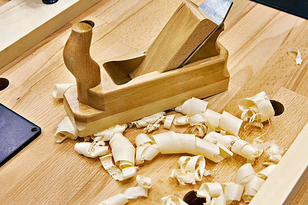 istock Handed planer on carpentry table and shavings 623179144