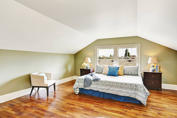 istock Spacious upstairs bedroom with vaulted ceiling and hardwood floor 623179828