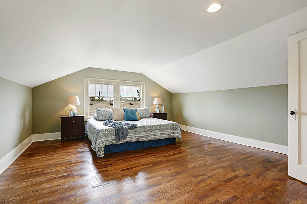 istock Spacious upstairs bedroom with vaulted ceiling and hardwood floor 623179880