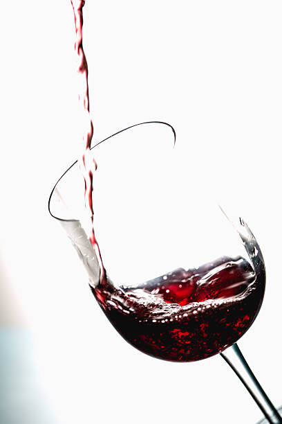 istock Pouring wine into the glasses, white background, isolated 623182678
