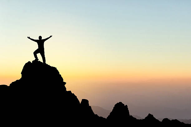 istock Silhouette of a man on a mountain top. 623183258