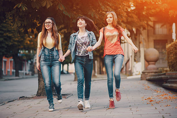 istock three young girls walking in the park 623183862