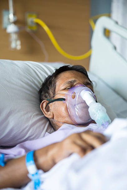 istock Old woman with Ventilator mask on Hospital bed 623185364