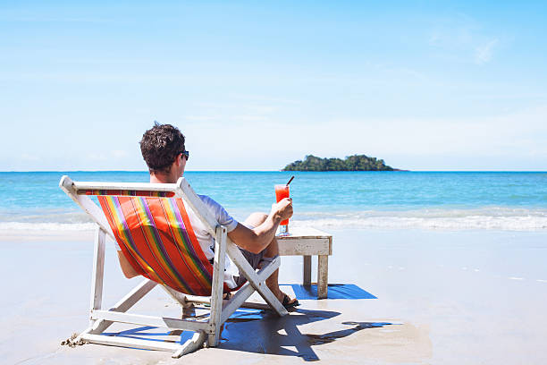 relaxation, tourist with cocktail, beach holidays man relaxing on private beach on paradise island, luxurious holidays, tourist with cocktail sitting near the sea military private stock pictures, royalty-free photos & images