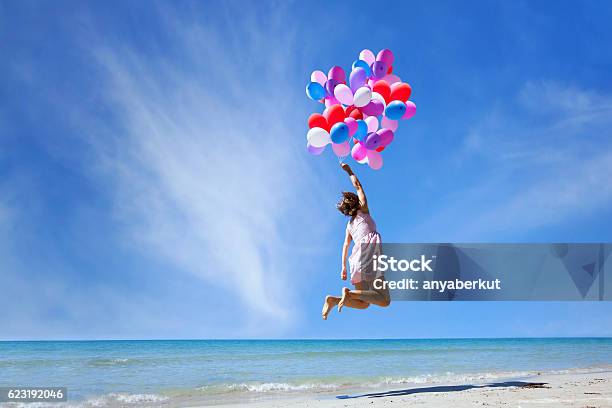 Dream Concept Girl Flying With Multicolored Balloons Jump Stock Photo - Download Image Now