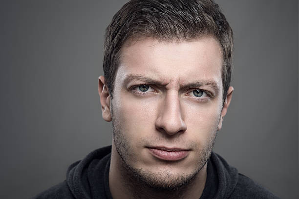 istock Close up portrait of distrustful young man looking at camera 623192240