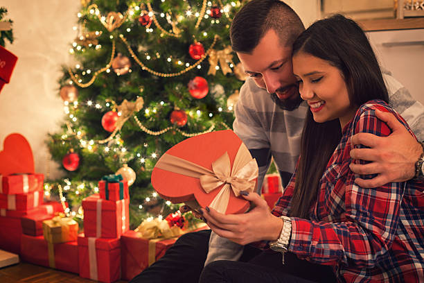 istock Happy Couple Opening Christmas Presents 623193322