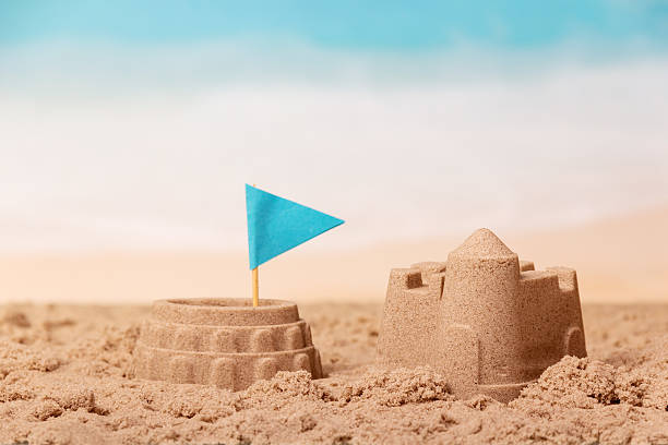 istock Coliseum with flag and tower in sand against sea. 623196844
