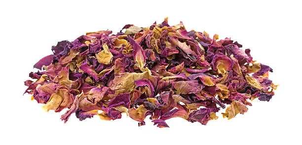 A portion of dried red rosebuds and petals that have been crushed isolated on a white background.