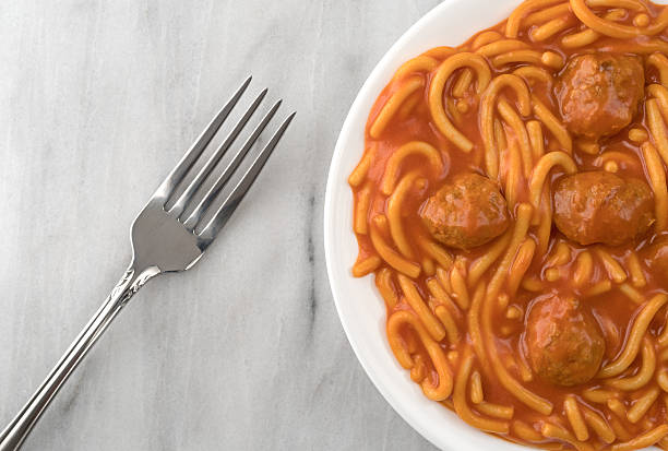 istock Plate of spaghetti and meatballs with fork on marble 623197954