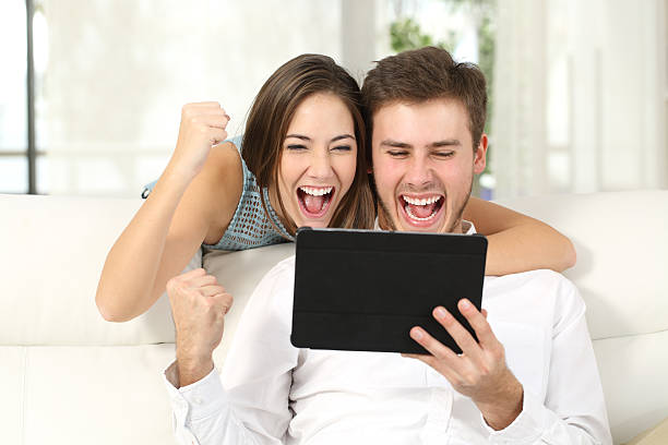 istock Excited couple winning online with tablet 623204830
