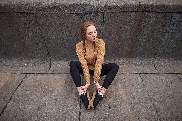 istock Blonde girl sutting on the ground 623204942
