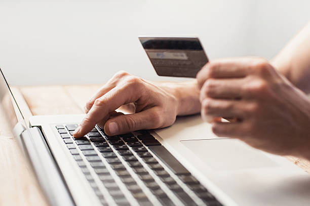 istock Man is shopping online with laptop 623205312