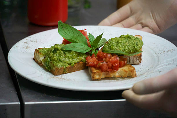 istock Plate of bruschetta bread with tomato and pesto sauce 623206590