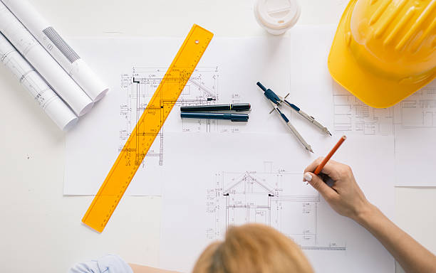 Construction engineer drawing project Architect drawing blueprint. High angle view. blueprint industry work tool planning stock pictures, royalty-free photos & images