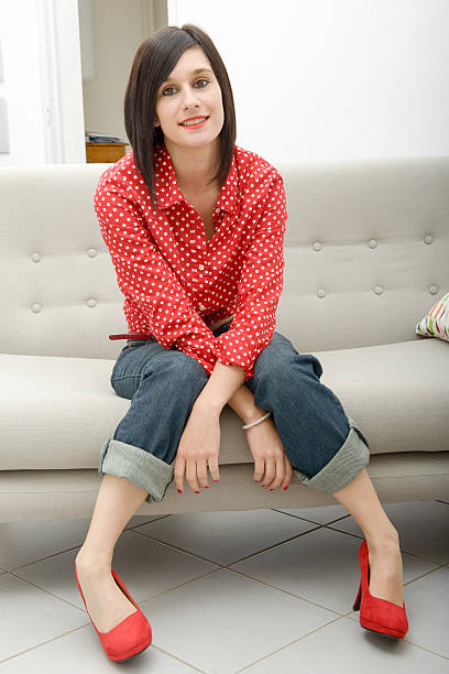 istock young woman with jeans sitting in the sofa 623207830