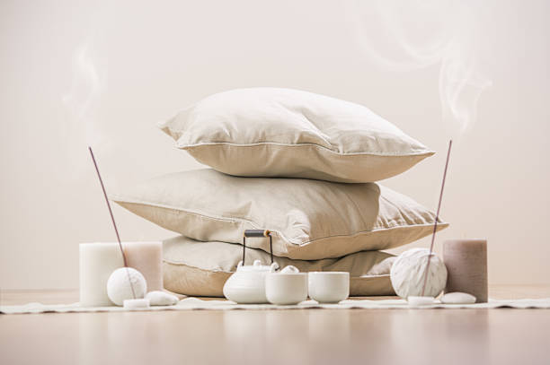 Tea set with incense sticks and candles with pillows stock photo