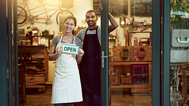 it's official! we're open for business - placard women holding standing imagens e fotografias de stock