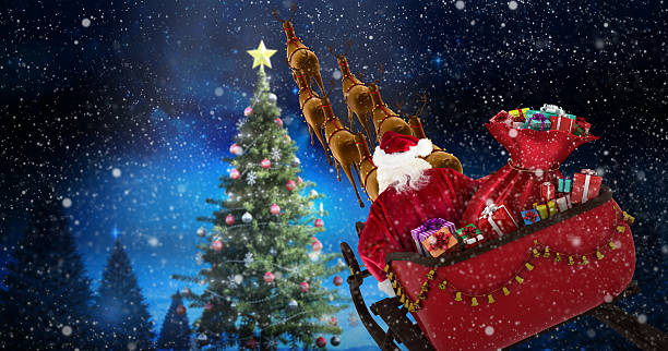 istock Santa Claus riding on sled against forest at night 623209158