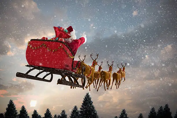 Photo of Santa Claus riding on sleigh with gift box