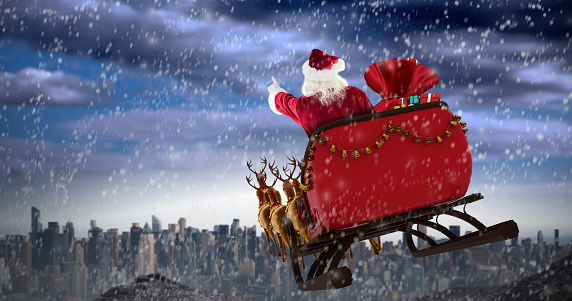 Santa Claus riding on sled with gift box against large city on the horizon