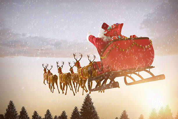 istock Santa Claus riding on sled against snow falling 623209364