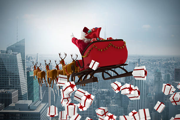istock White and red christmas presents against cityscape 623209504