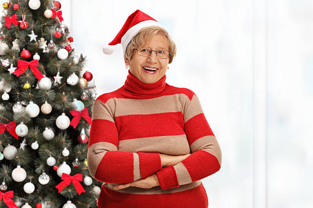 istock Elderly woman posing in front of Christmas tree 623210428