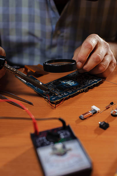 istock Closeup of male hands soldering computer board 623212904