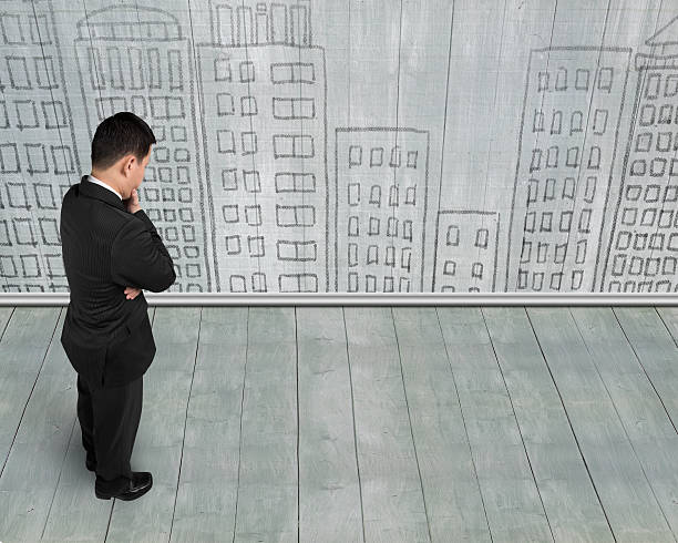 istock Standing businessman holding hand on chin and thinking 623213832