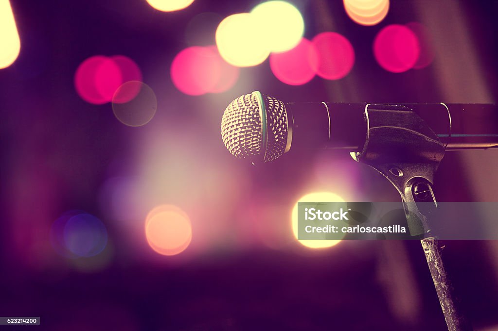 Microphone and stage lights.Concert and music concept Live music background.Microphone and stage lights Microphone Stock Photo