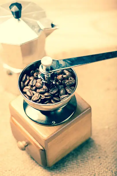coffee beans in  coffee Grinders and moka pot vintage tone style