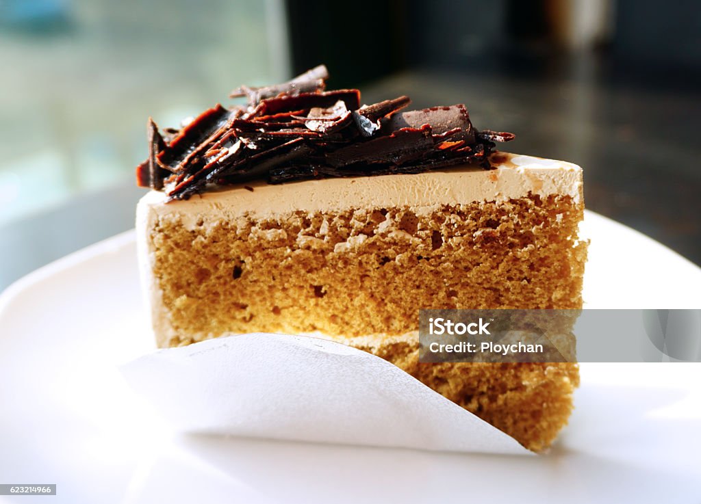 Piece of mocca coffee cake on white plate Piece of mocca coffee cake on white platePiece of mocca coffee cake on white plate Cake Stock Photo