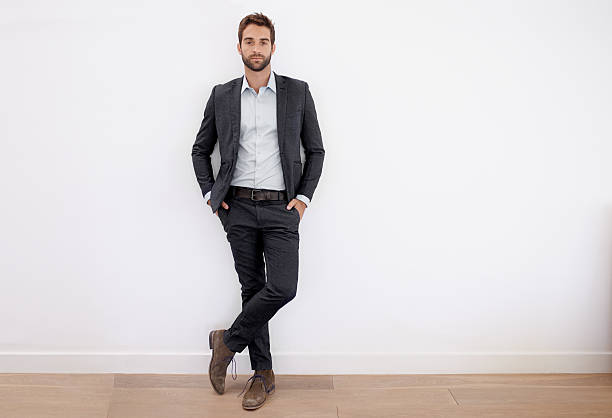 Dressed in his business best Full body shot of a handsome and stylish young businessman blazer jacket stock pictures, royalty-free photos & images