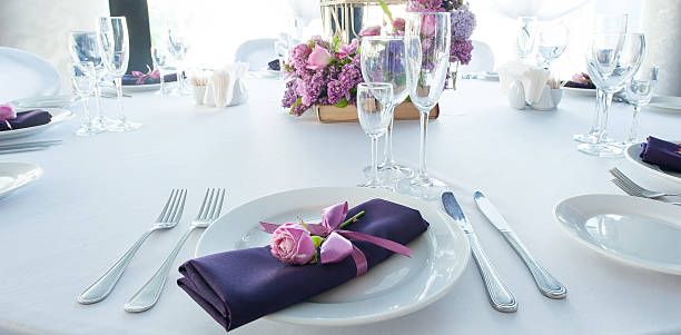 Festive table setting in the restaurant with flowers. Wedding decor.