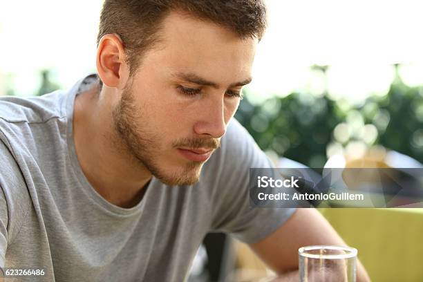 Sad Man Drinking In A Bar Stock Photo - Download Image Now - Men, Guilt, Alcohol - Drink