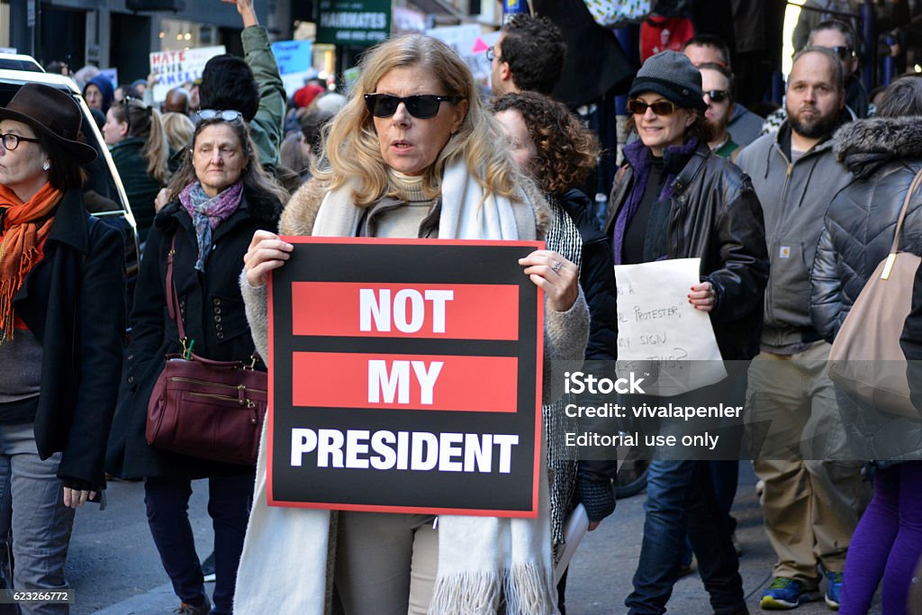New York City New York, New York - November 12, 2016: Protester carrying a sign while marching in a "Trump is not my President" rally in response to the 2016 Presidential Election of Donald Trump in New York City in 2016. Donald Trump - US President Stock Photo