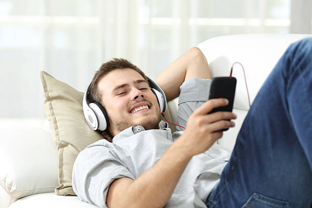 istock Happy man listening music at home 623267144