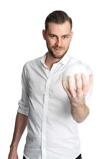 A man in a white shirt holding a crystal ball looking in to the future. White background.