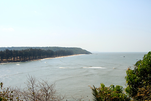 Goa, India - March 03, 2015: View Querim beach from the hill on the opposite bankGoa, India - March 03, 2015: View Querim beach from the hill on the opposite bank